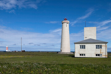 Fototapeta na wymiar Gardskagi Lighthouse located in Keflavik, Iceland with Old Gardur Lighthouse in the background