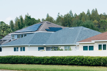 Obraz premium Solar panel on a house roof; Green energy from sun 