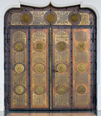 A metal brass door with bronze decorations