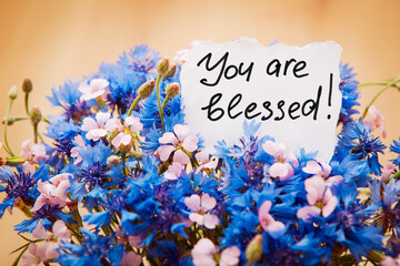You are blessed - card with lettering and blue cornflower flowers, christian motivation phrase