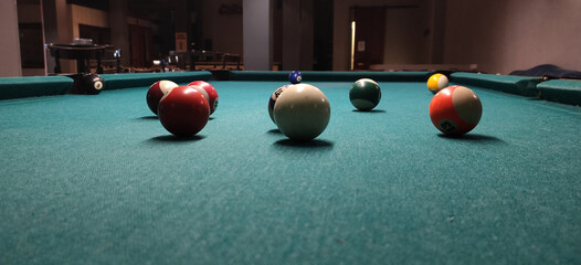 Close up view of a Billiard table with balls in an empty bar