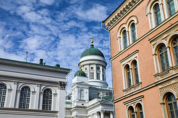 Fototapeta na wymiar View of the beautiful Helsinki Cathedral through colorful buildings