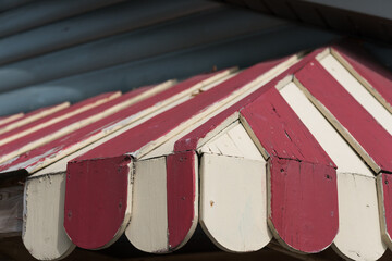 wooden roof (awning) painted ivory and red