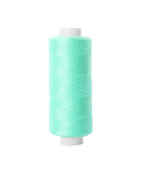 Spool of turquoise sewing thread isolated on white