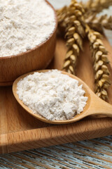 Fototapeta na wymiar Organic wheat flour on wooden table, closeup