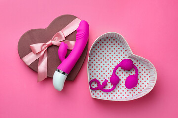 Gift box with sex toys on pink background, flat lay