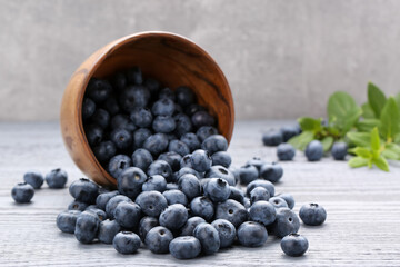 Tasty fresh blueberries on wooden table, closeup