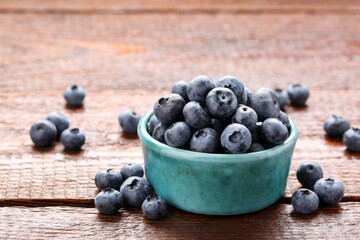 Tasty fresh blueberries on wooden table, closeup