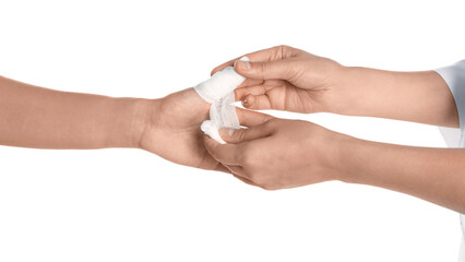 Doctor applying bandage onto patient's thumb on white background, closeup