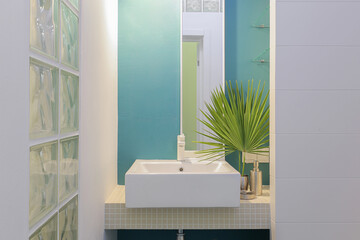Faucet with white ceramic sink in the bathroom