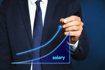 Salary increase concept. Man drawing up arrow on virtual screen, closeup