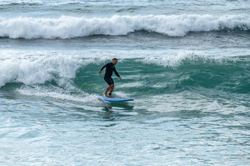 Surfer in action at sunset. Furadouro beach, Ovar - Portugal.