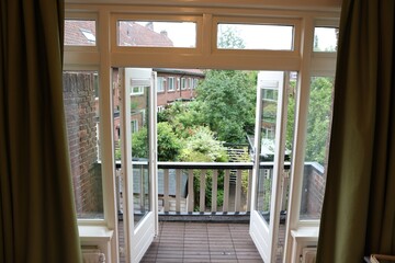 Beautiful view on balcony and inner yard with green trees from apartment