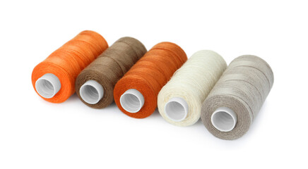 Set of different colorful sewing threads on white background