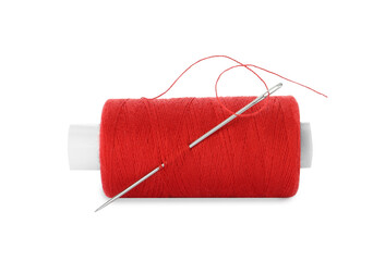 Spool of red sewing thread with needle isolated on white