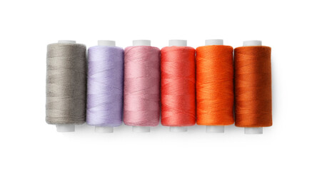Set of different colorful sewing threads on white background, top view