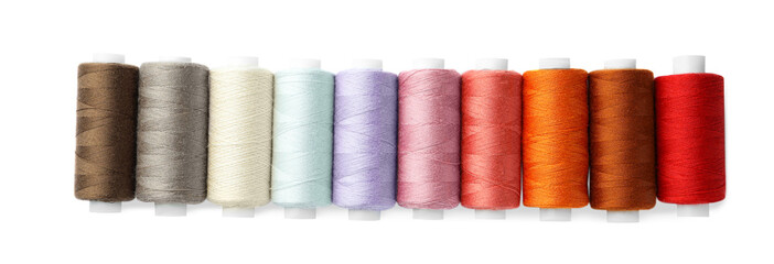 Set of different colorful sewing threads on white background, top view