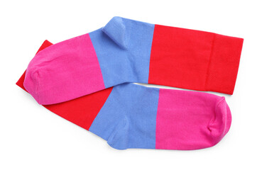 Pair of colorful striped socks on white background, top view