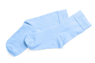 Pair of light blue socks on white background, top view
