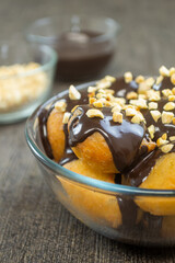 Loukoumades (Greek Donuts) or donat yunani combined with melted chocolate topping, have a crunchy texture on the outside and soft on the inside.