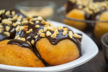Loukoumades (Greek Donuts) or donat yunani combined with melted chocolate topping, have a crunchy...