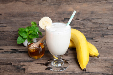 Banana fresh cocktail vanilla smoothies  fruit juice beverage healthy the taste yummy in glass drink episode good morning on wooden background.