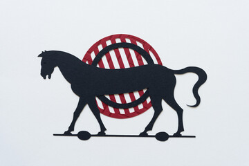 hobby (or trojan) horse (dingbat) on an abstract paper gridiron shape or target (focusing ring)
