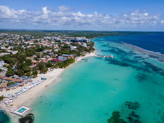 Beautiful aerial view of Boca Chica beach, its turquoise waters, resorts near the Santo Domingo...