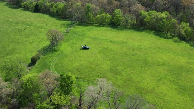Professional Land Surveyors Surveying Farmland Property Near Siloam Springs In Arkansas, USA. aerial drone orbit