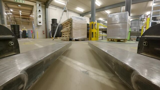 First Person View Of A Pair Of Blade Growing And Carrying A Load Cover Of Cellophane Plastic.