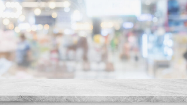 Empty white marble stone table top and blur glass window interior shop and store banner mock up abstract background - can used for display or montage your products.