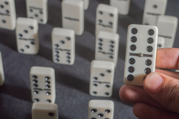 Several domino pieces positioned on a black background with light light