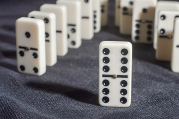 Several domino pieces positioned on a black background with light light
