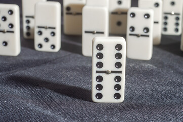 Several domino pieces positioned on a black background with light light