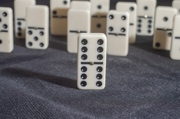 Several domino pieces positioned on a black background with light light