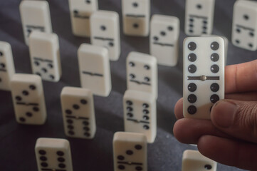 Several domino pieces positioned on a black background with light light