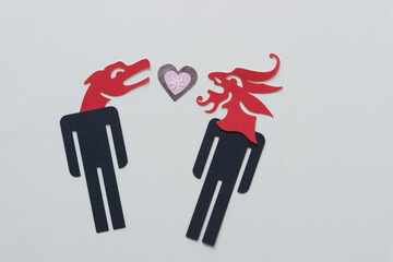 stick figure dingbats with heads of dragons and a fancy paper heart on blank paper