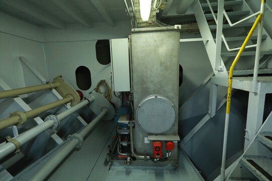 Cruise ship engine room interior with water tight doors electrical and diesel engines, water pipes, measuring instruments, diesel engines