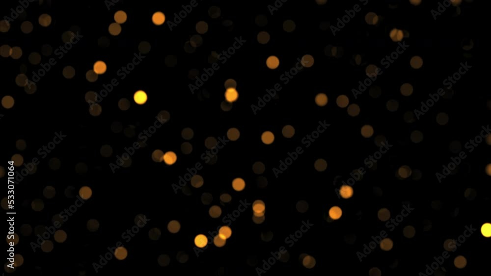 Poster beautiful loopable falling circle glitter glow orange bokeh particles on black background for screen