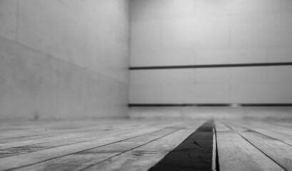 selective focus on a section of wood planking at floor level inside a racquet ball court
