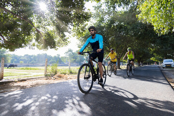 Fototapeta premium Confident cyclists riding bicycle on countryside road 