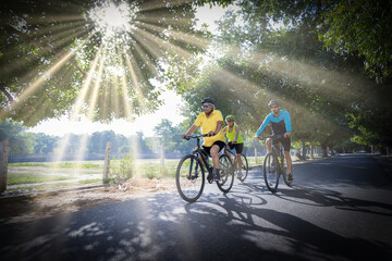 Confident cyclists riding bicycle on countryside road
 - obrazy, fototapety, plakaty