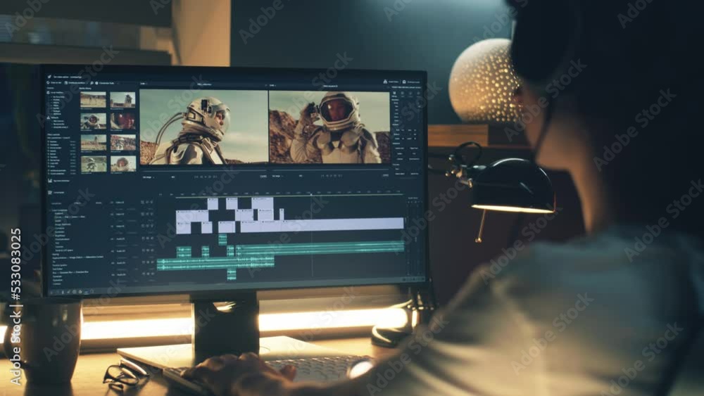 Poster male editor in headphones sitting at the table at night and editing video with astronauts for custom