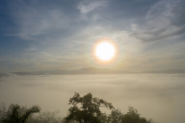 aerial view beautiful yellow sunrise above the mountain in phang Nga valley..slow floating fog blowing cover on the mountain look like as a sea of mist. .scenery golden sunrise at horizon background.