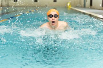 Fototapeta na wymiar Swimming - male swimmer, man in indoor pool