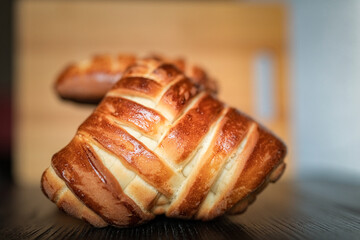 Delicious homemade rich organic buns on a wooden background.