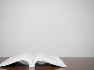 Text book on the table white wall background