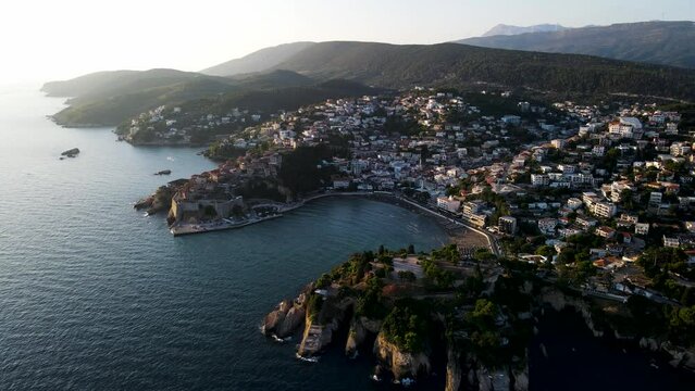 Aerial view of Ulcinj, a small town on a rocky promontory along the Mediterranean coastline in Montenegro during sunset.