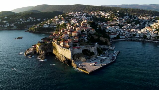 Aerial view of Ulcinj, a small town on a rocky promontory along the Mediterranean coastline in Montenegro during sunset.