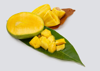 Jackfruit And Mango cut on leaves. tropical summer fruits in Asia. isolated studio photo. refreshing hot day fruit salad.